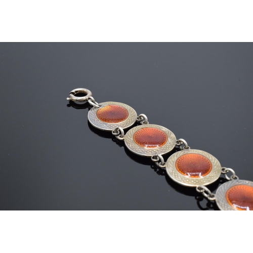 557 - A 20th century sterling silver and red enamel bracelet. 14.5 grams. 19cm long. In good condition gen... 