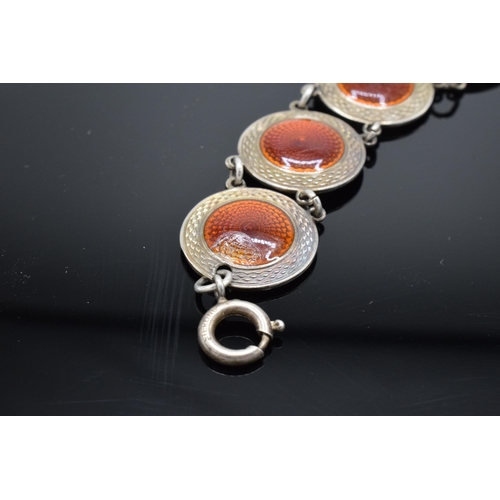 557 - A 20th century sterling silver and red enamel bracelet. 14.5 grams. 19cm long. In good condition gen... 