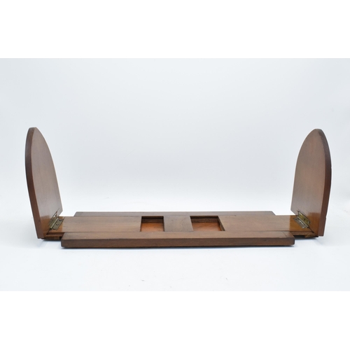 153 - An early 20th century wooden and brass adjustable bookshelf. 54cm at longest. In good condition.