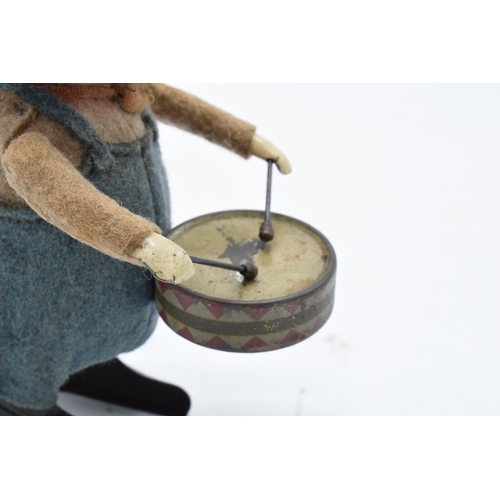 182 - A Schuco circa 1930s clockwork toy figure in the form of a pig with a drum. Based on the Three Littl... 