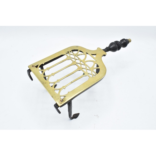 282 - Victorian brass and iron trivet with wooden handle (some chipping to wood).