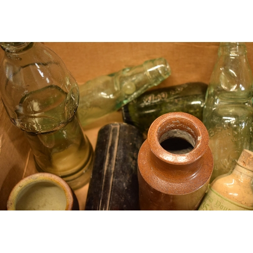 31 - A mixed collection of vintage items to include stoneware jars and advertising glass bottles to inclu... 