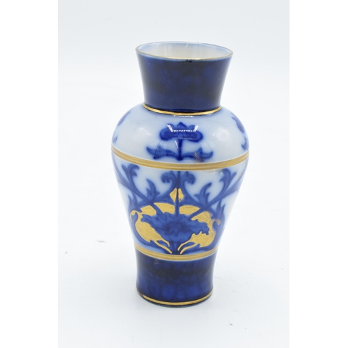 75 - A Macintyre / Moorcroft small baluster vase with stylised decoration. 11cm tall. In good condition w... 