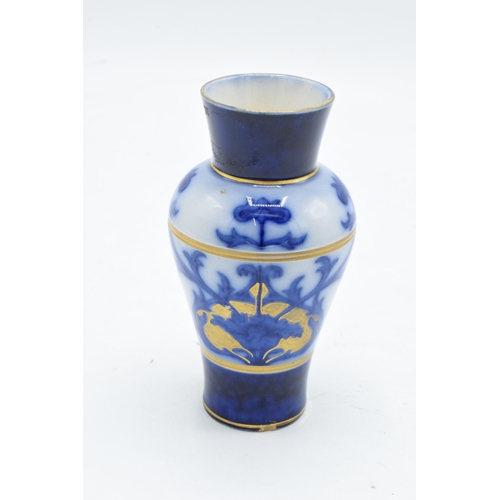 75 - A Macintyre / Moorcroft small baluster vase with stylised decoration. 11cm tall. In good condition w... 