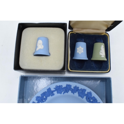 77 - A collection of Wedgwood Jasperware to include a boxed green and blue thimble set, a Josiah Wedgwood... 