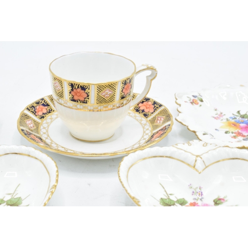 83 - A collection of Royal Crown Derby items to include an Imari cup and saucer, Derby posies pin trays e... 