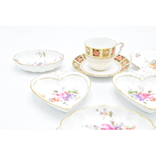 83 - A collection of Royal Crown Derby items to include an Imari cup and saucer, Derby posies pin trays e... 