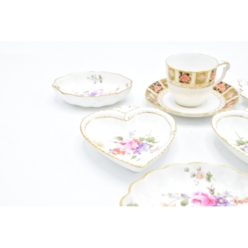 83 - A collection of Royal Crown Derby items to include an Imari cup and saucer, Derby posies pin trays e... 