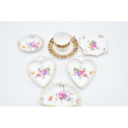 83 - A collection of Royal Crown Derby items to include an Imari cup and saucer, Derby posies pin trays e... 