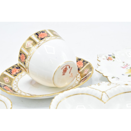 83 - A collection of Royal Crown Derby items to include an Imari cup and saucer, Derby posies pin trays e... 