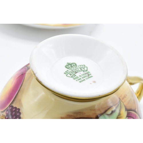 85 - Aynsley cup and saucer in the Orchard Gold design (2). In good condition with no obvious damage or r... 