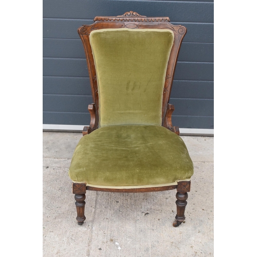 297 - Edwardian green upholstered parlour chair with carved decoration. 90cm tall.