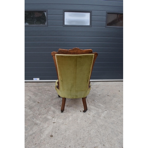 297 - Edwardian green upholstered parlour chair with carved decoration. 90cm tall.