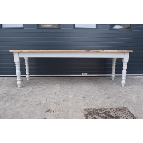 299 - A grand 8ft long 20th century pine topped farmhouse table sat on baluster legs. Painted with a vinta... 