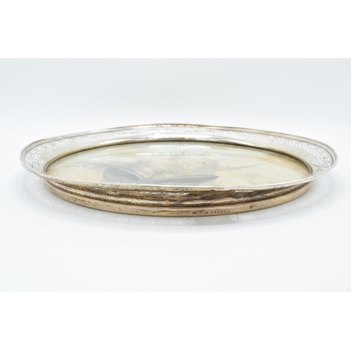 389B - An unusual sterling silver circular tray with pierced edges decorated with dried glass and foliage. ... 