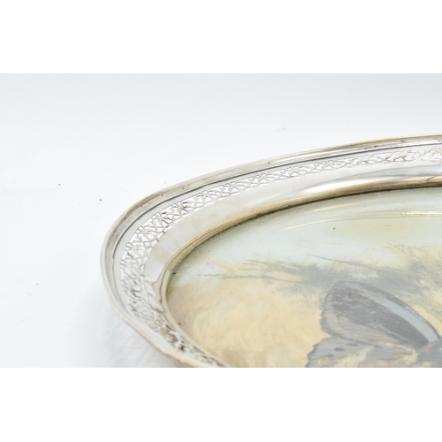 389B - An unusual sterling silver circular tray with pierced edges decorated with dried glass and foliage. ... 