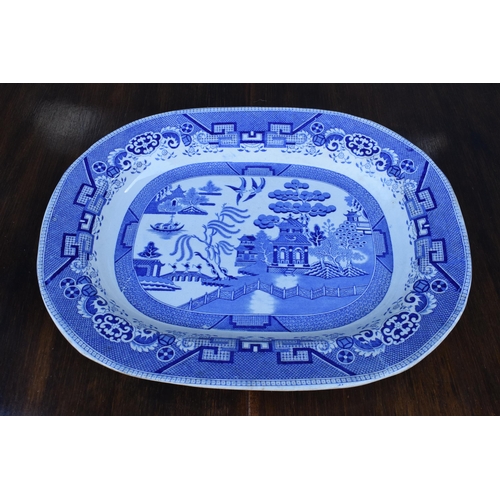 110A - A large 19th century blue and white meat platter with transfer decoration of idealised landscape wit... 