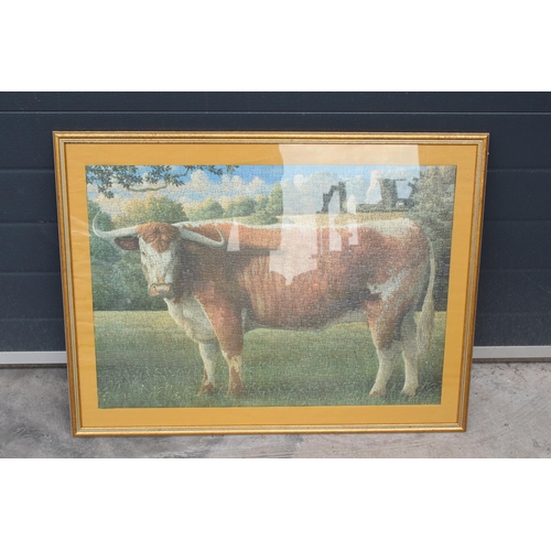 210C - A framed jigsaw of a Longhorn cow in a wooden frame