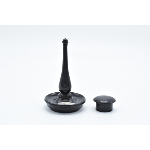 179 - An ebony ring stand with a silver mount (London) together with an ebony circular pill box (2). 11cm ... 