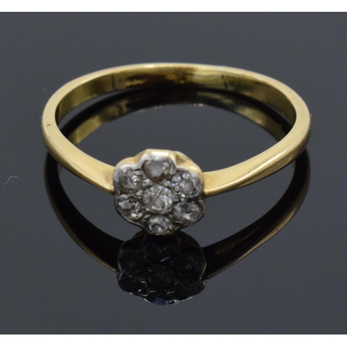 189 - 18ct gold daisy ring set with diamonds. UK size O. 2.1 grams. In good condition.