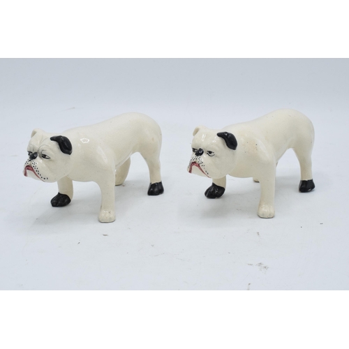 101 - A pair of 19th century pottery bulldogs standing square (2). In good condition with no obvious damag... 