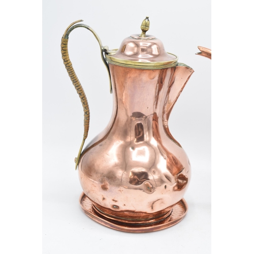 204 - A Henry Loveridge arts and crafts hammered copper spirit kettle on a stand together with a copper co... 