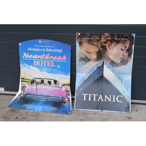 218 - A large collection of large movie and music posters and prints to include examples such as Titanic, ... 