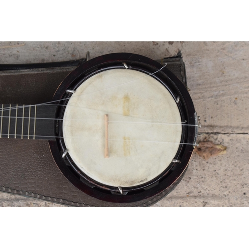 223 - A vintage cased Keech Banjolele Banjo. Will need re-stringing / some attention.