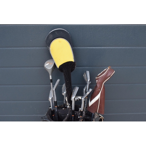 224 - A collection of golf clubs in a Maxfli golfing bag with brands to include Wilson, Hippo etc. Will ne... 