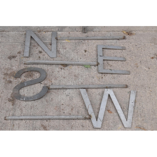 226 - A large stainless steel plasma cut weathervane in the form of a cockerel with letters N E S W on met... 