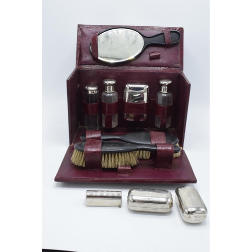 229 - An early 20th century travelling vanity set in a leather carry case