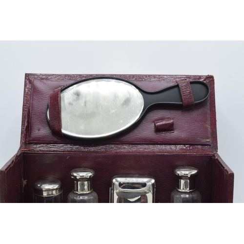 229 - An early 20th century travelling vanity set in a leather carry case