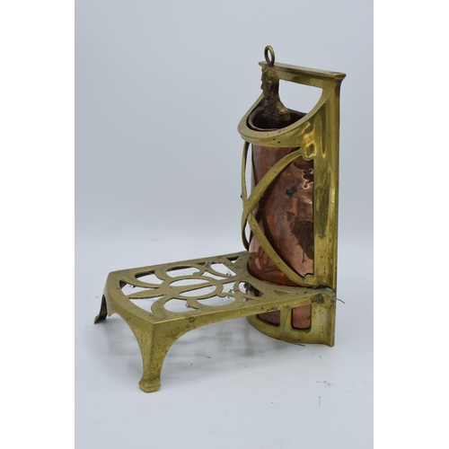 240 - An early 20th century brass and copper fireside trivet / companion set holder. 28cm tall.