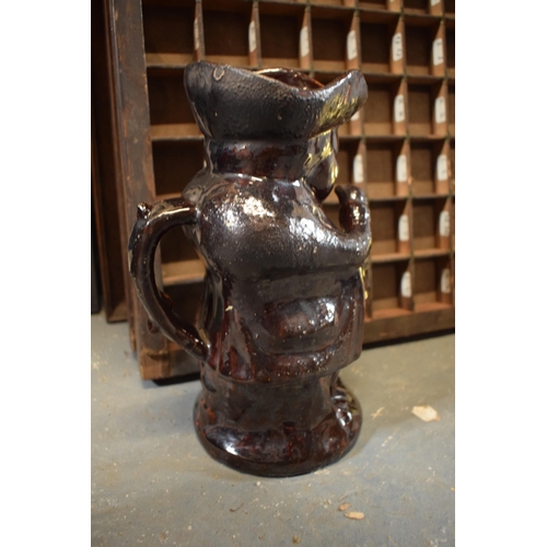 25 - A 19th century treacle glaze or similar Toby jug together with a selection of silver plated spoons e... 