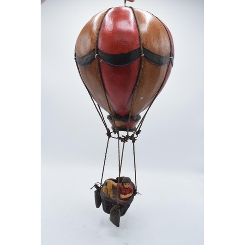 262 - A painted hanging model of a hot air balloon group, the red and white balloon above a wicker basket ... 