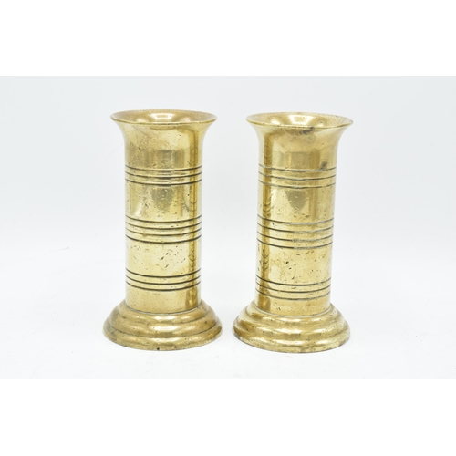 266 - A collection of metalware to include a pair of Art Nouveau style vases by Tamco, a pair of trench ar... 