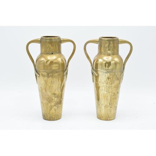 266 - A collection of metalware to include a pair of Art Nouveau style vases by Tamco, a pair of trench ar... 