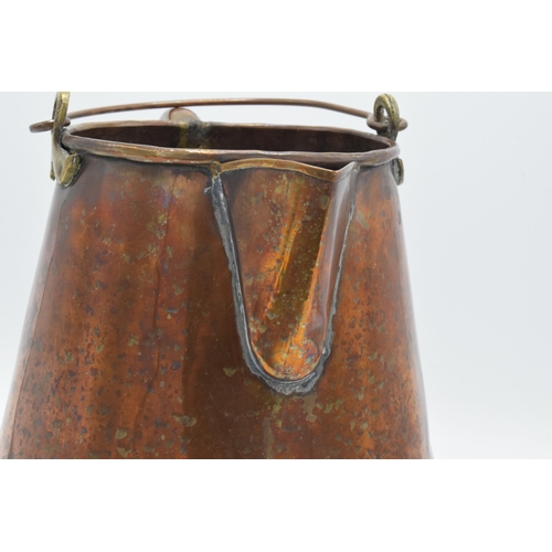 270 - An unusual 19th century copper jug / pouring vessel with brass mounts. 24cm tall.