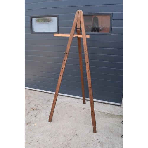 295 - An early 20th century large wooden freestanding folding easel. In good functional condition. Some ol... 