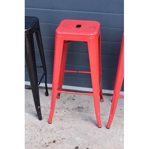 307 - A collection of industrial style metal stacking stools (4). 76cm tall. In good functional condition ... 