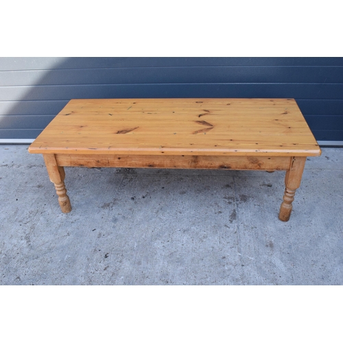 311 - A 20th century solid low pine side table / coffee table. 152 x 70 x 51cm tall. In good functional co... 