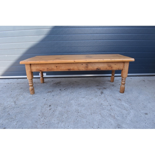 311 - A 20th century solid low pine side table / coffee table. 152 x 70 x 51cm tall. In good functional co... 