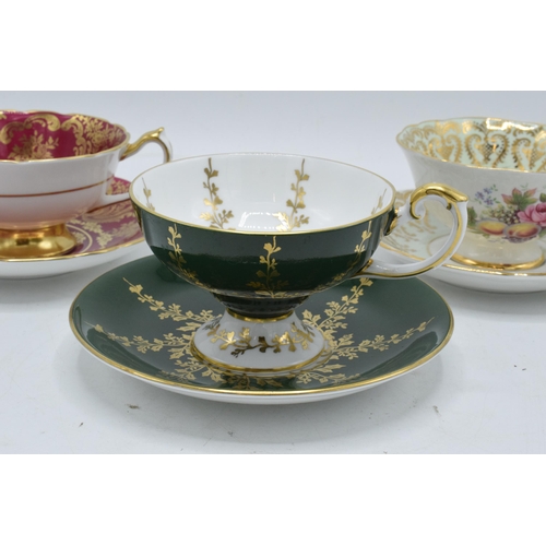 59 - A collection of cups and saucers / duos to include Aysnley and Paragon depicting regal style scenes ... 