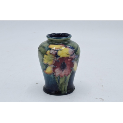 97 - Moorcroft small bulbous vase in the Orchid (or similar) design. 9cm tall. In good condition with no ... 