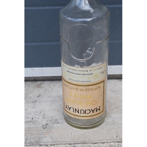 275 - Mackinlay's Old Scotch Whiskey large bottle. 48cm tall. In good condition.