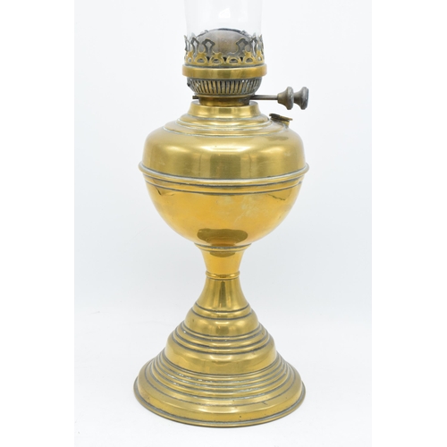 312 - A 20th century brass oil lamp with an associated shade. 32cm tall without shade. 'Best English Make'