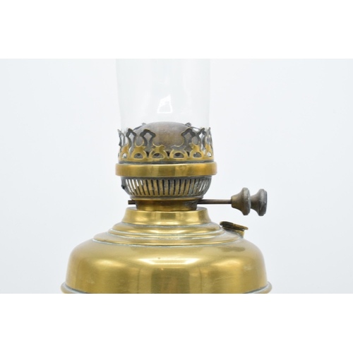 312 - A 20th century brass oil lamp with an associated shade. 32cm tall without shade. 'Best English Make'