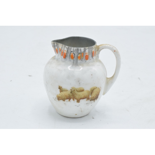 128 - Royal Doulton miniature seriesware jug depicting sheep in a wintery scene. 6cm tall. In good conditi... 