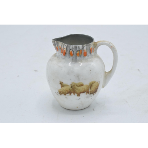 128 - Royal Doulton miniature seriesware jug depicting sheep in a wintery scene. 6cm tall. In good conditi... 