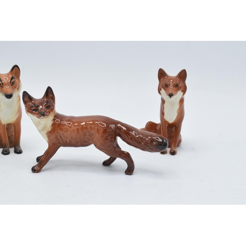 161 - A collection of Beswick foxes to include standing fox 1440 x 2 and seated fox 1748 x 3 (5) with some... 